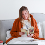 Must Read Books during social distancing featured by popular US Lifestyle Blogger, The Fashionista Momma; woman in bed reading a book